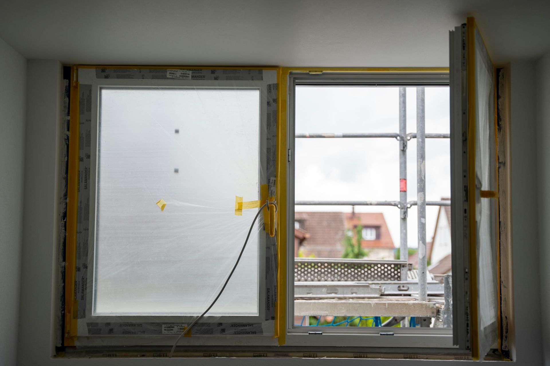 Open window with construction happening outside